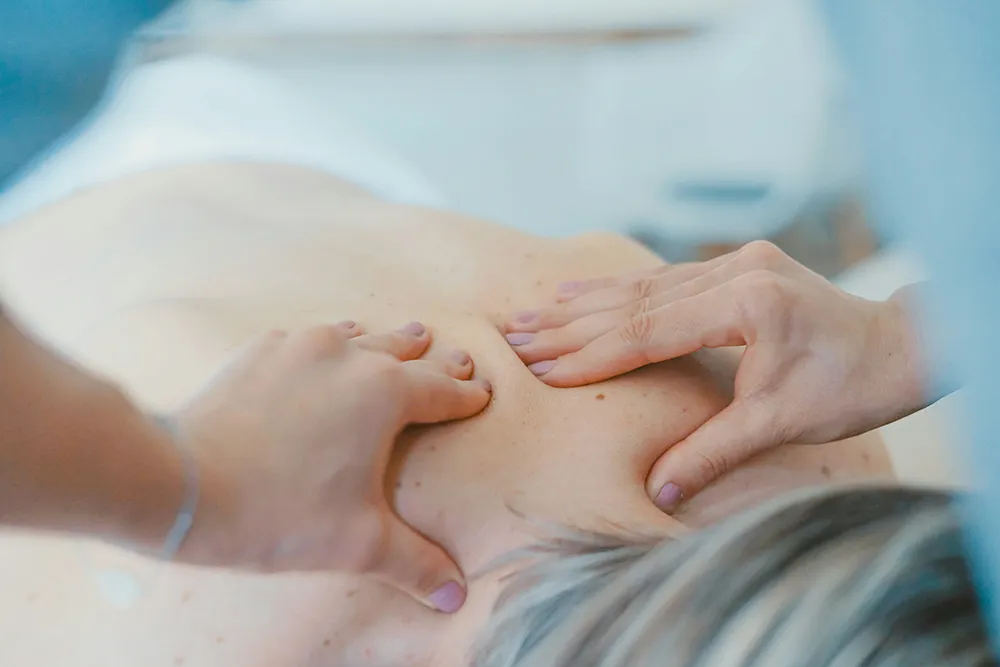 Massage thérapeutique du dos, illustrant les soins médicaux chez EV Clinic
